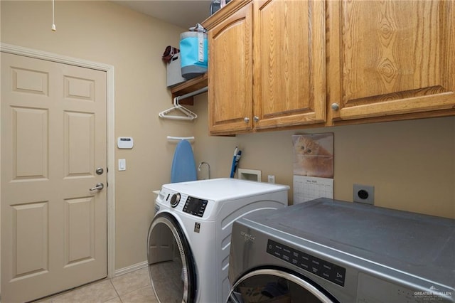 5109 Quince Ave, Mcallen, TX 78501 - laundry area featuring cabinet space, washing machine and clothes dryer, light tile patterned floors, and baseboards