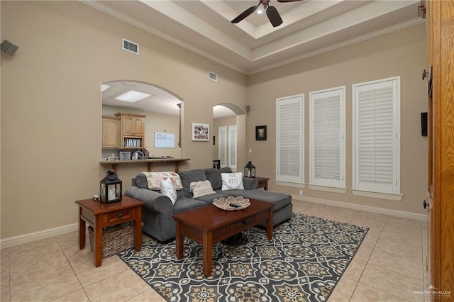 5109 Quince Ave, Mcallen, TX 78501 - living area featuring arched walkways, light tile patterned floors, ceiling fan, a high ceiling, and a raised ceiling