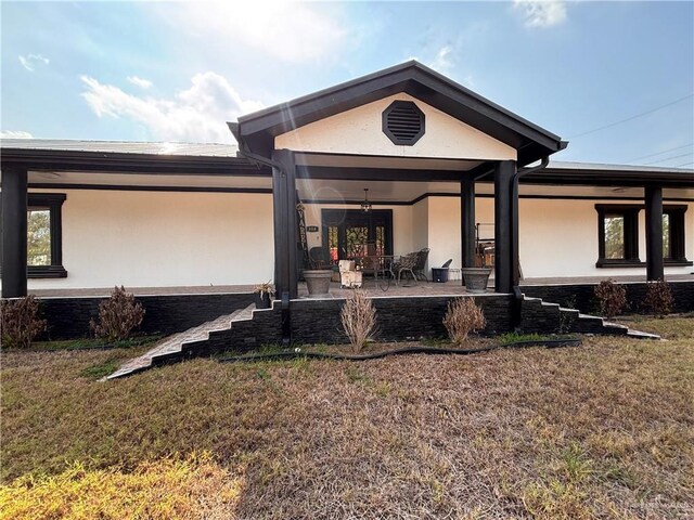 858 S La Homa Rd S, Mission, TX 78573 - rear view of property featuring stucco siding, a yard, and a patio