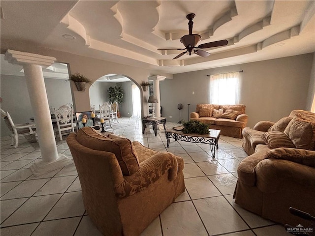 858 S La Homa Rd S, Mission, TX 78573 - living room featuring decorative columns, arched walkways, a raised ceiling, a ceiling fan, and light tile patterned flooring