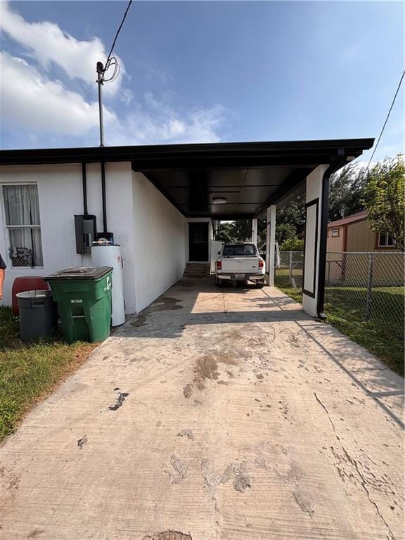 858 S La Homa Rd S, Mission, TX 78573 - view of vehicle parking with fence, water heater, driveway, and a carport