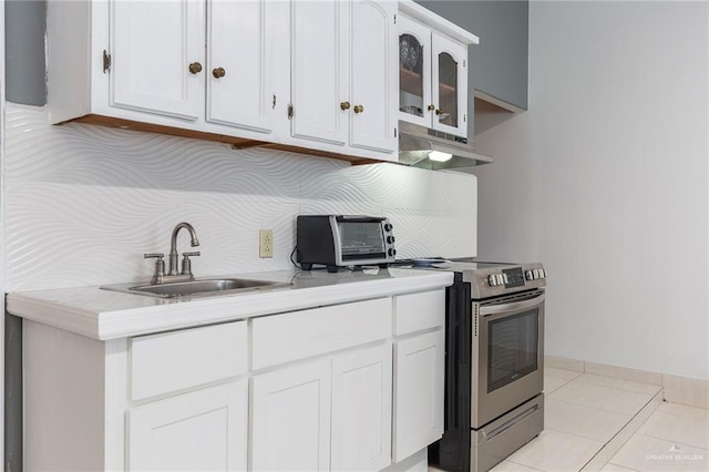 kitchen with white cabinetry, sink, electric range, range hood, and light tile patterned floors