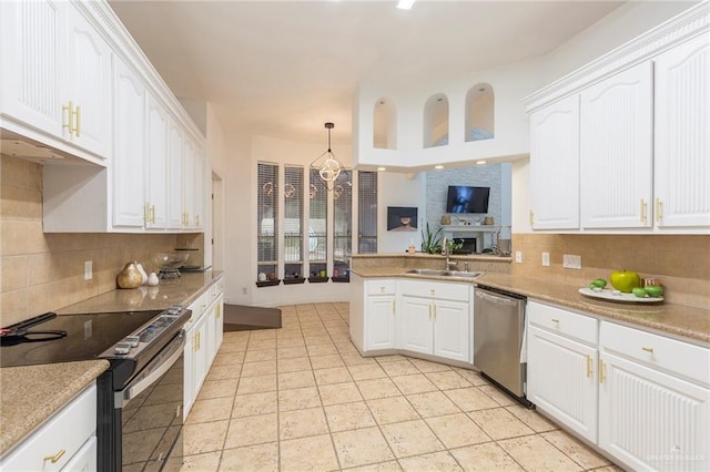 kitchen with white cabinetry, sink, stainless steel appliances, and decorative light fixtures