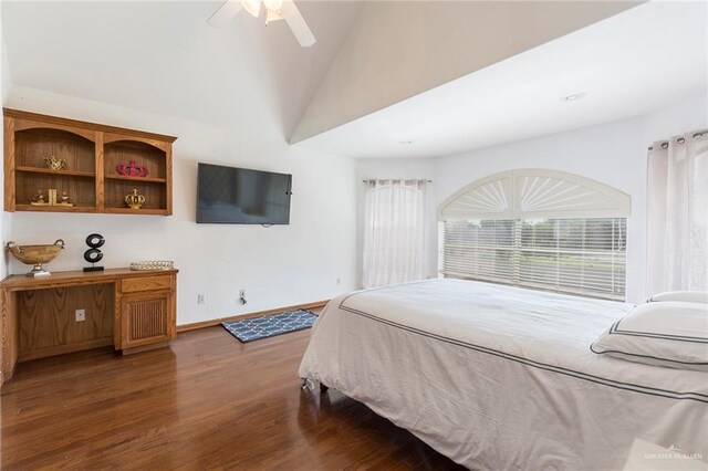 bedroom featuring dark hardwood / wood-style floors, vaulted ceiling, and ceiling fan