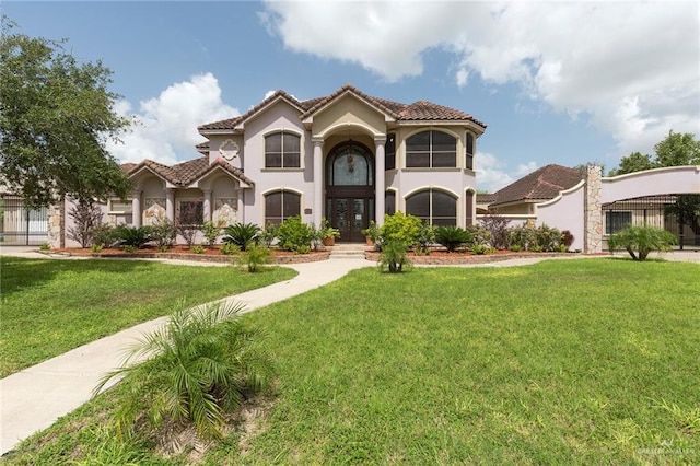 mediterranean / spanish home featuring a front yard