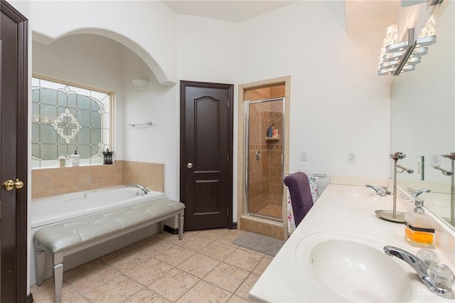 bathroom with vanity and separate shower and tub