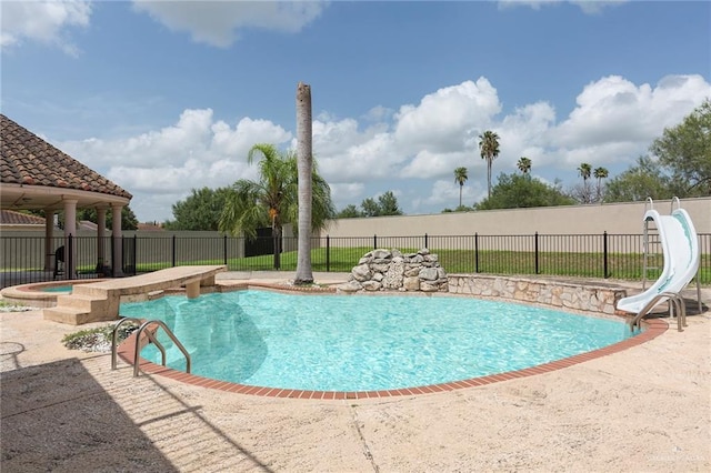 view of pool with a jacuzzi and a water slide