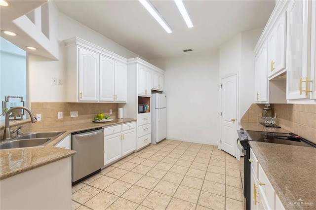 kitchen with light tile patterned flooring, stainless steel appliances, white cabinetry, and sink