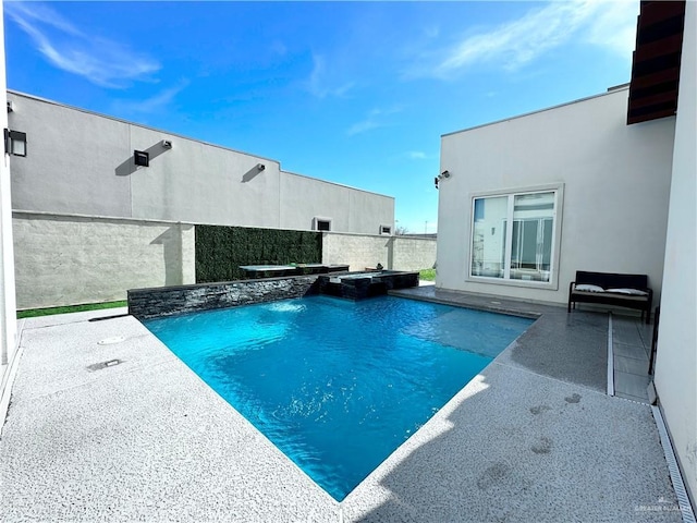 view of swimming pool featuring a pool with connected hot tub and a patio