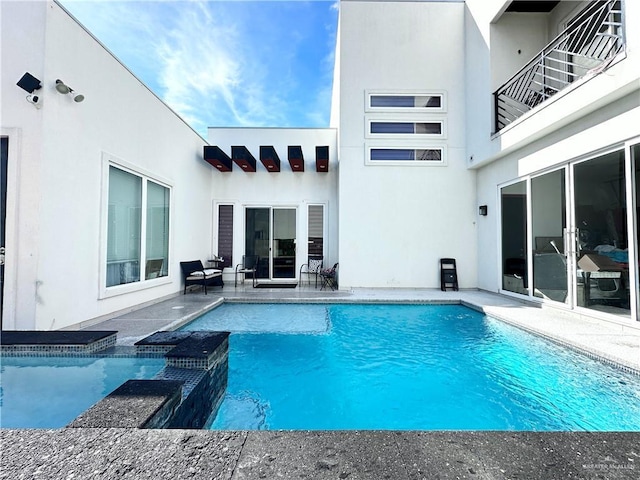 view of pool featuring a pool with connected hot tub and a patio