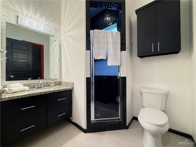 full bathroom featuring tile patterned flooring, toilet, vanity, baseboards, and a stall shower