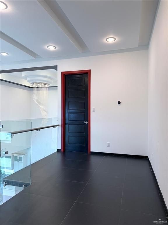 spare room featuring recessed lighting and baseboards