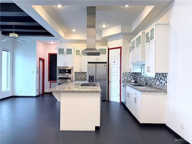 kitchen with a sink, white cabinetry, appliances with stainless steel finishes, a center island, and island exhaust hood