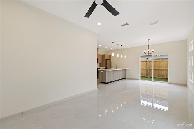 1901 W Violet Dr, Pharr, TX 78577 - unfurnished living room featuring ceiling fan, a chandelier, a sink, recessed lighting, and baseboards