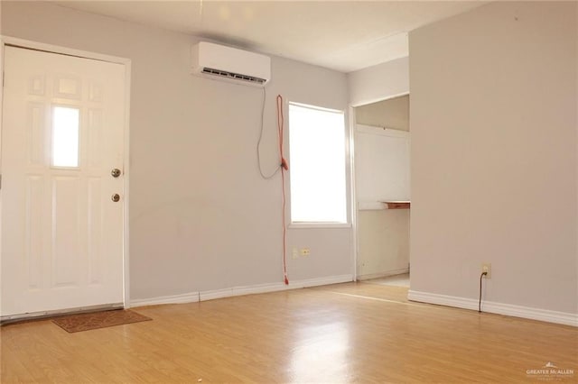 entrance foyer with a wall mounted air conditioner and light wood-type flooring