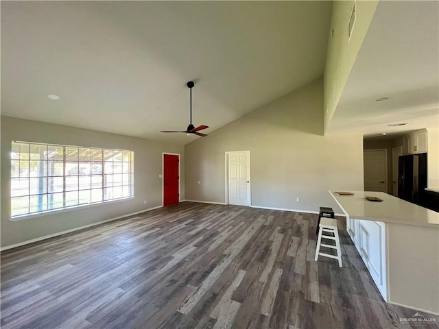 1115 Falcon Dr, Harlingen, TX 78550 - unfurnished living room featuring dark hardwood / wood-style flooring and high vaulted ceiling