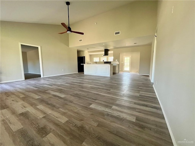 1115 Falcon Dr, Harlingen, TX 78550 - unfurnished living room featuring ceiling fan, high vaulted ceiling, and wood-type flooring