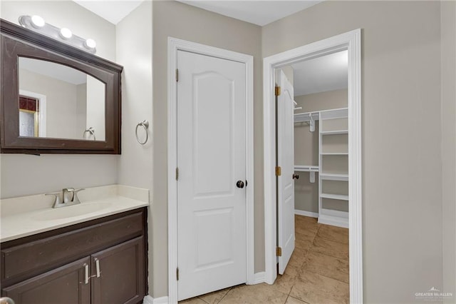 1821 S Petunia Ave, Weslaco, TX 78596 - bathroom with vanity, tile patterned floors, and a spacious closet
