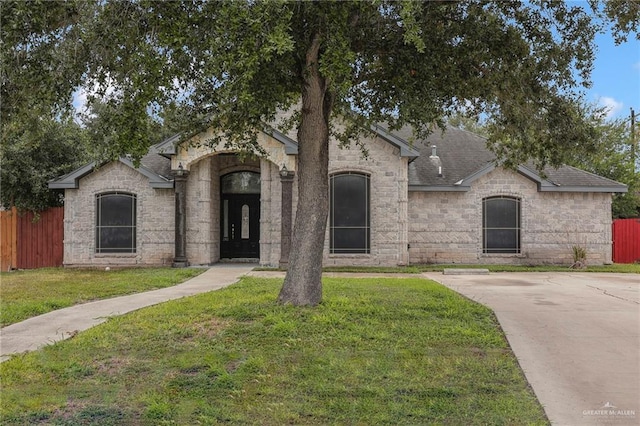 1821 S Petunia Ave, Weslaco, TX 78596 - french country inspired facade with a shingled roof and stone siding