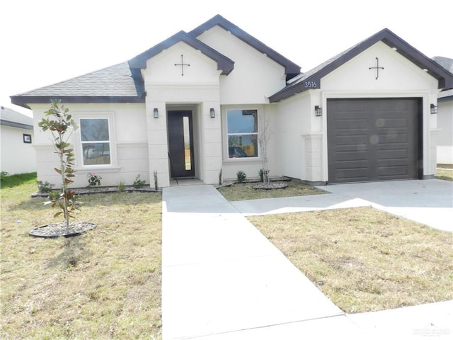 view of front of property featuring a garage and a front lawn