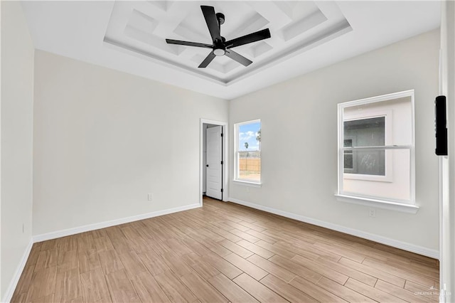 unfurnished room featuring a raised ceiling and ceiling fan