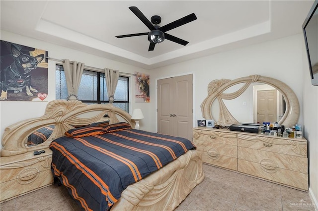 1904 E Hibiscus Ave, Hidalgo, TX 78557 - tiled bedroom featuring a tray ceiling and a ceiling fan