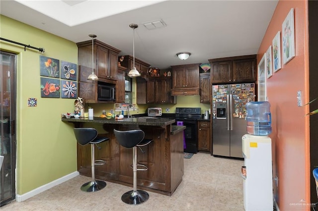 1904 E Hibiscus Ave, Hidalgo, TX 78557 - kitchen with black / electric stove, stainless steel fridge with ice dispenser, built in microwave, a peninsula, and dark brown cabinets
