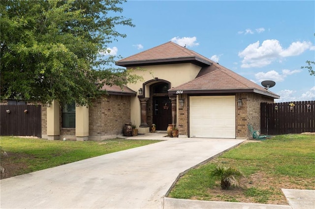 1904 E Hibiscus Ave, Hidalgo, TX 78557 - view of front of property with an attached garage, driveway, and brick siding