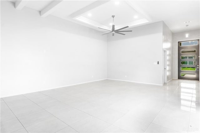 spare room featuring light tile patterned floors, a raised ceiling, and ceiling fan