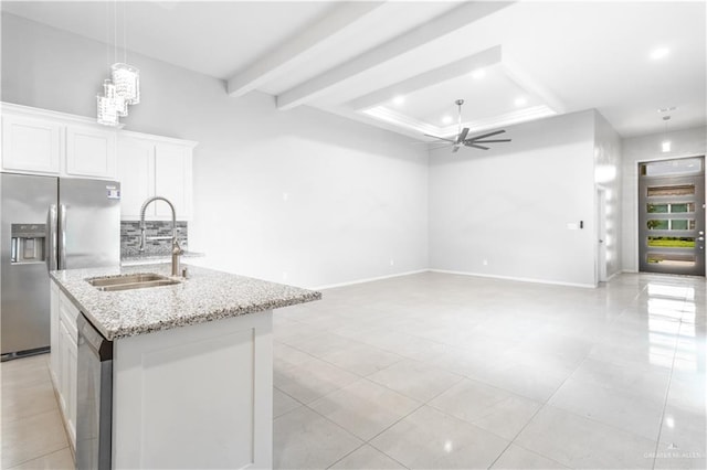 kitchen with white cabinets, sink, ceiling fan, an island with sink, and appliances with stainless steel finishes