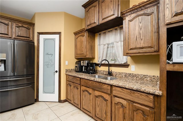 5514 N Minnesota Rd, Mission, TX 78574 - kitchen featuring stainless steel fridge with ice dispenser, light stone countertops, white microwave, and light marble finish flooring