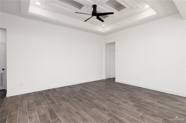 spare room with ceiling fan, dark wood-type flooring, and coffered ceiling