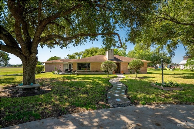 5129 N Mile 5 1/2 Rd W, Weslaco, TX 78599 - ranch-style home featuring a front yard and a chimney