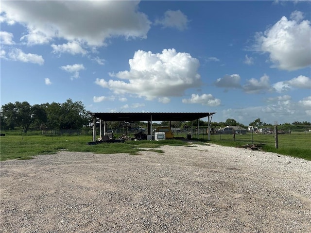 view of parking featuring a rural view and a carport