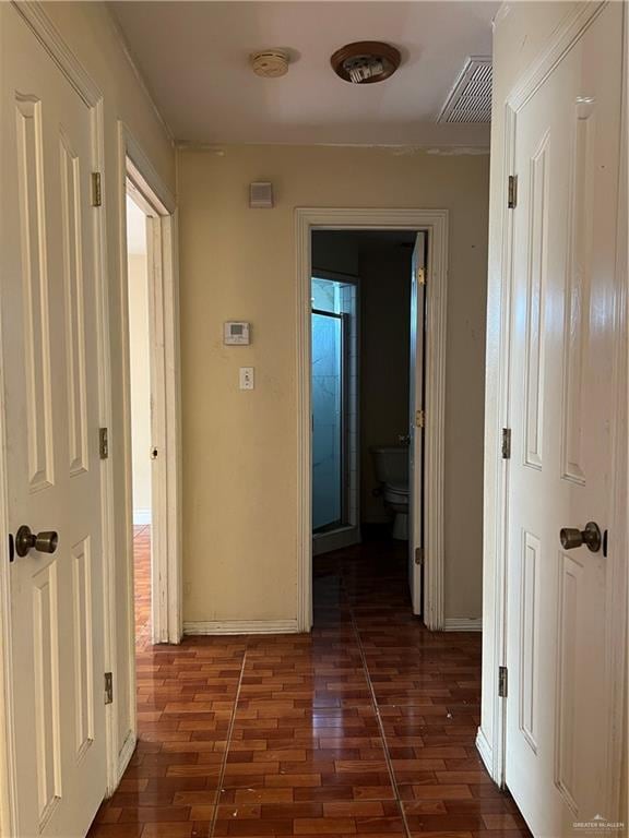 hall featuring dark wood-type flooring