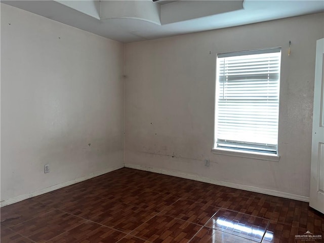 spare room with dark hardwood / wood-style floors and a wealth of natural light