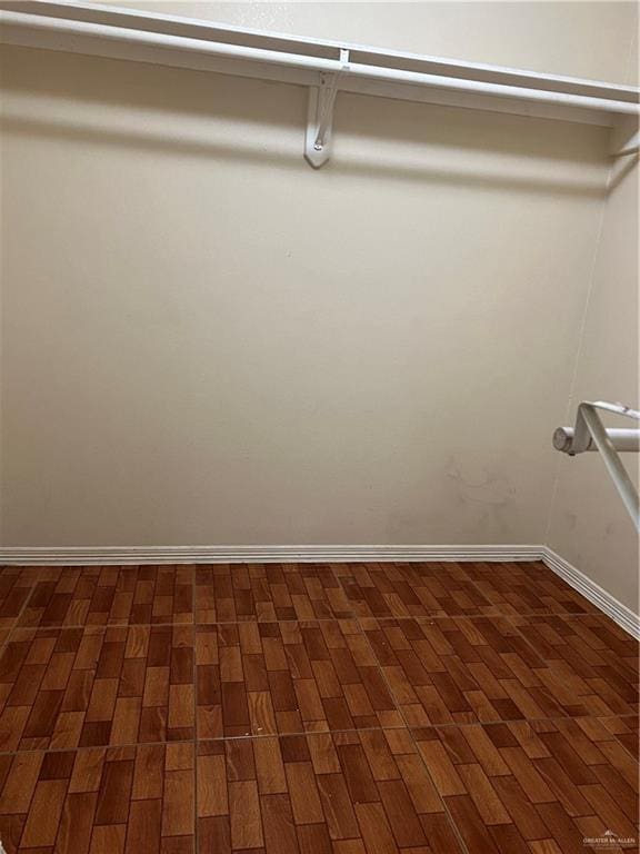 walk in closet featuring dark wood-type flooring