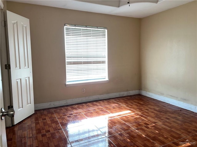 unfurnished room featuring dark hardwood / wood-style flooring and plenty of natural light