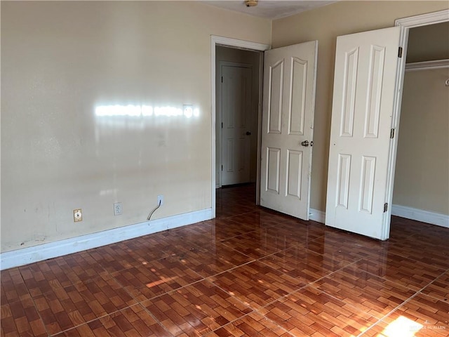 unfurnished bedroom featuring dark wood-type flooring