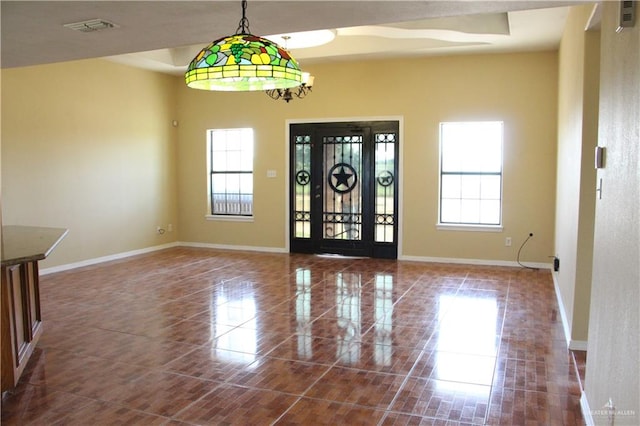 foyer with tile patterned floors and a wealth of natural light