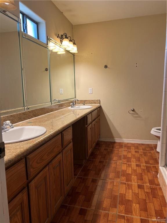 bathroom with wood-type flooring, vanity, and toilet