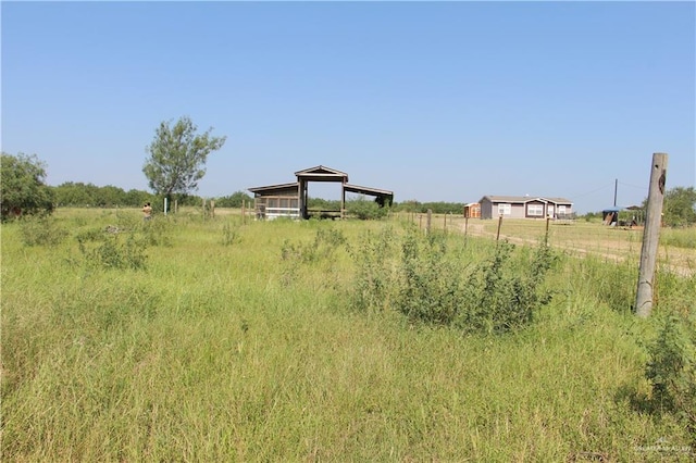 view of yard with a rural view