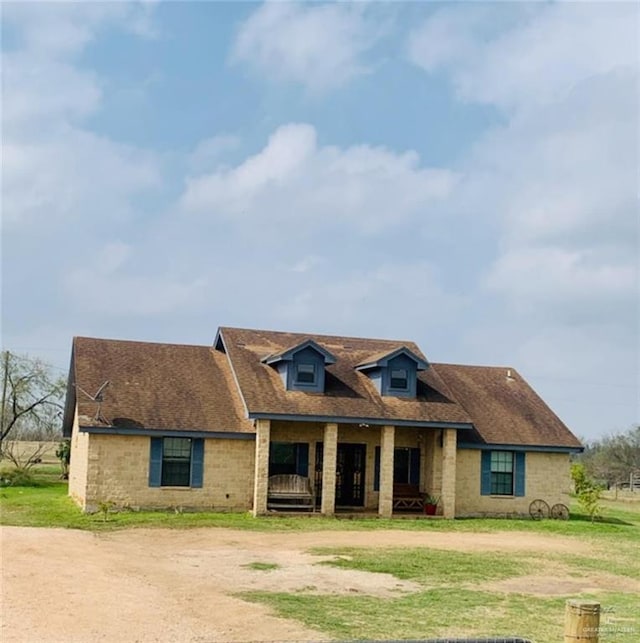 view of front of property with a porch and a front yard