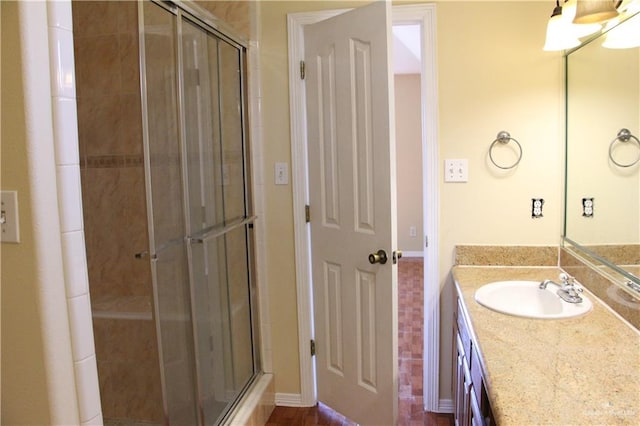 bathroom with vanity and a shower with shower door