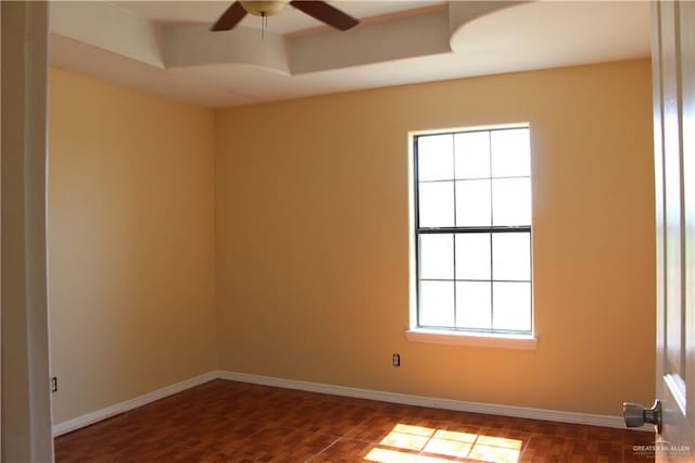 unfurnished room featuring plenty of natural light, dark hardwood / wood-style floors, and ceiling fan