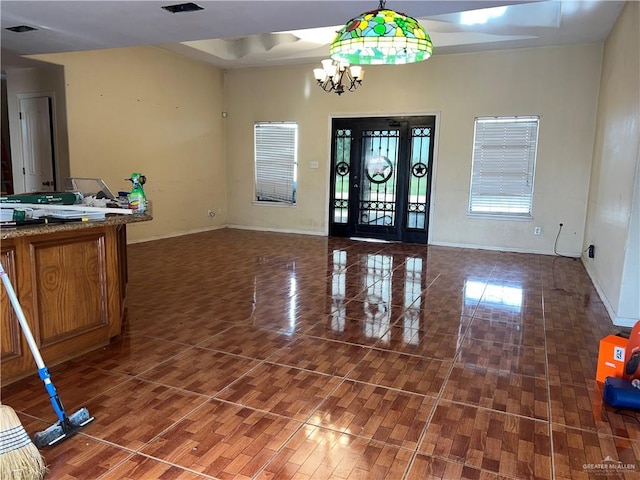 entryway with a notable chandelier and dark hardwood / wood-style flooring