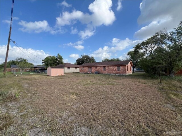 1116 S Orange St, Mercedes, TX 78570 - view of grassy yard with a storage unit