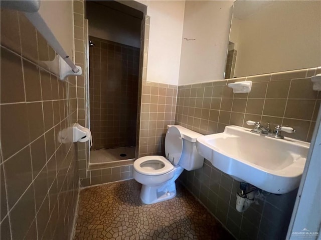 1116 S Orange St, Mercedes, TX 78570 - bathroom featuring a stall shower, tile walls, and a wainscoted wall