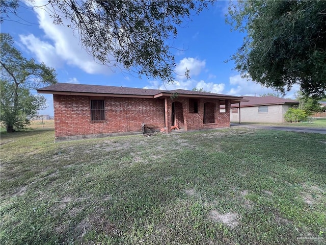 1116 S Orange St, Mercedes, TX 78570 - view of front of house with brick siding and a front lawn
