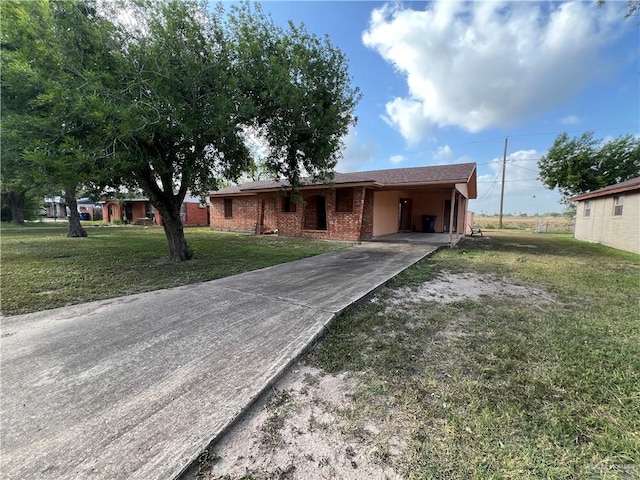 1116 S Orange St, Mercedes, TX 78570 - ranch-style home featuring driveway, a front lawn, a carport, and brick siding